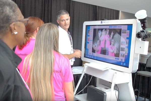 Garrick shows Juice Plus+ Live guests how to use the TapSnap kiosk