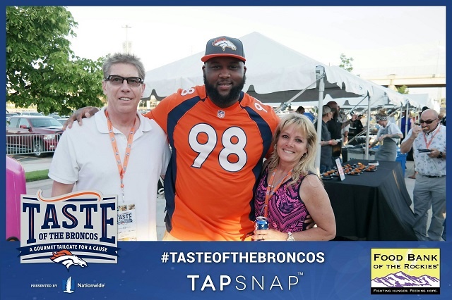 NFL fans pose with Denver Broncos player, Darius Kilgo.