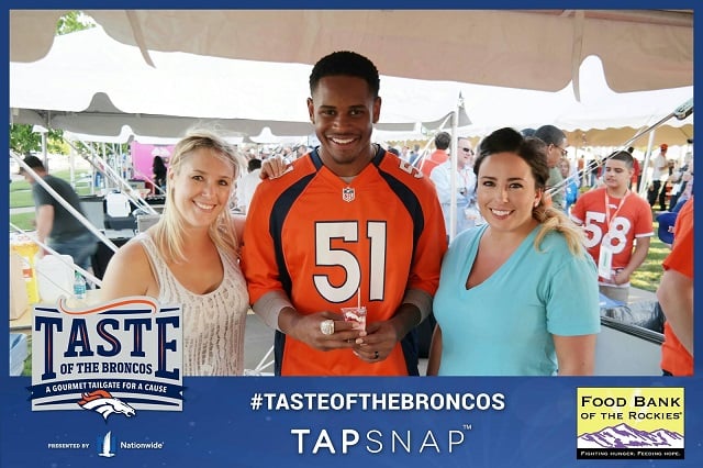 NFL fans pose with Denver Broncos player, Todd Davis.